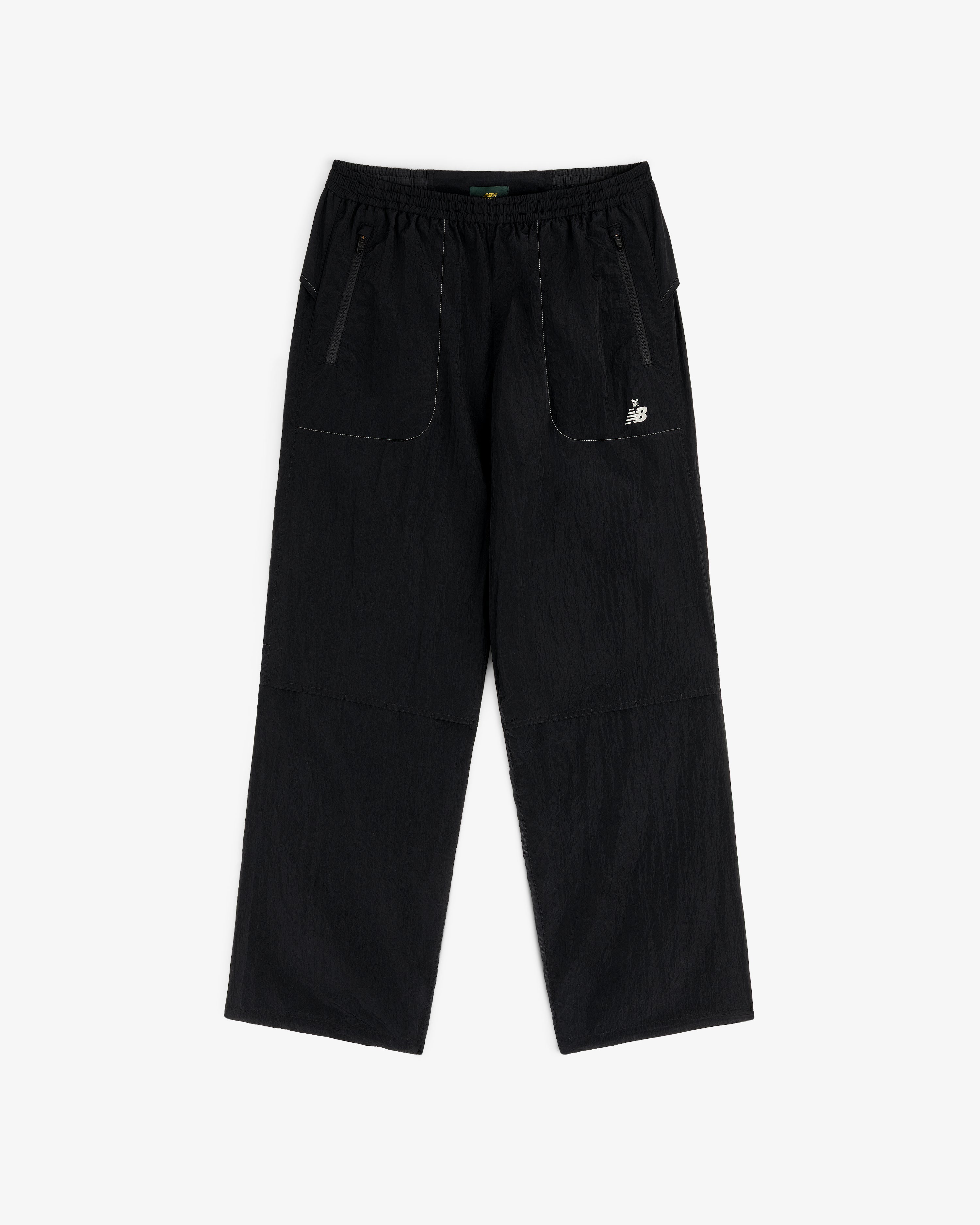 ALD / New Balance Lightweight Nylon Warmup Pant with wide legs, front patch pockets, elastic waist, and white logo.
