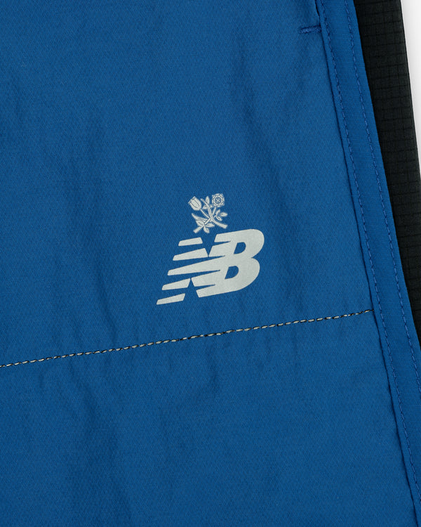 ALD / New Balance Performance Lightweight Running Short in blue, featuring a white NB logo and small crossed rose icons.