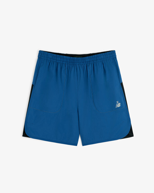 ALD / New Balance Performance Lightweight Running Short in blue with black panels, elastic waist, and logo on left leg.