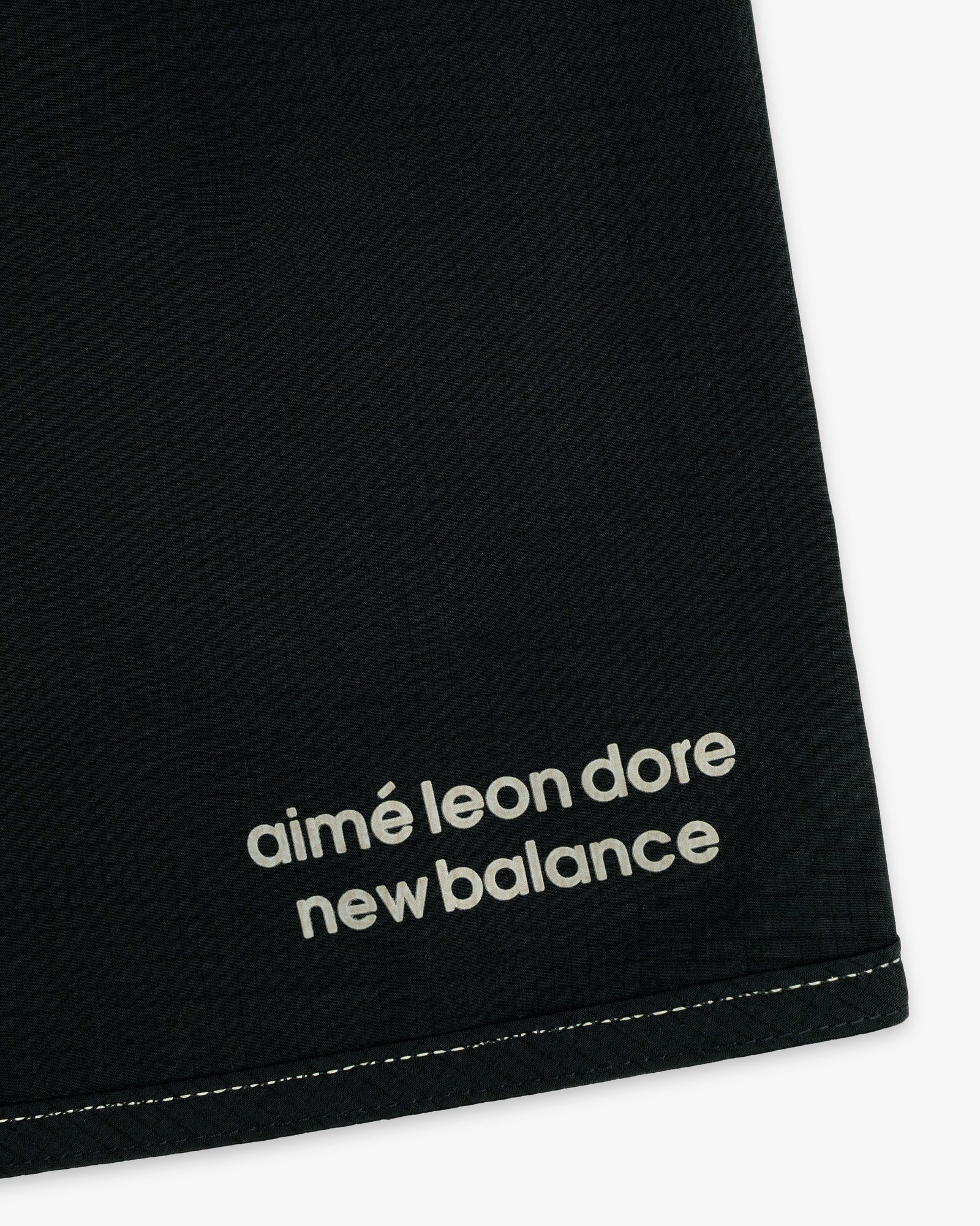 Black ALD / New Balance Performance Lightweight Running Short with white logo near a stitched edge.