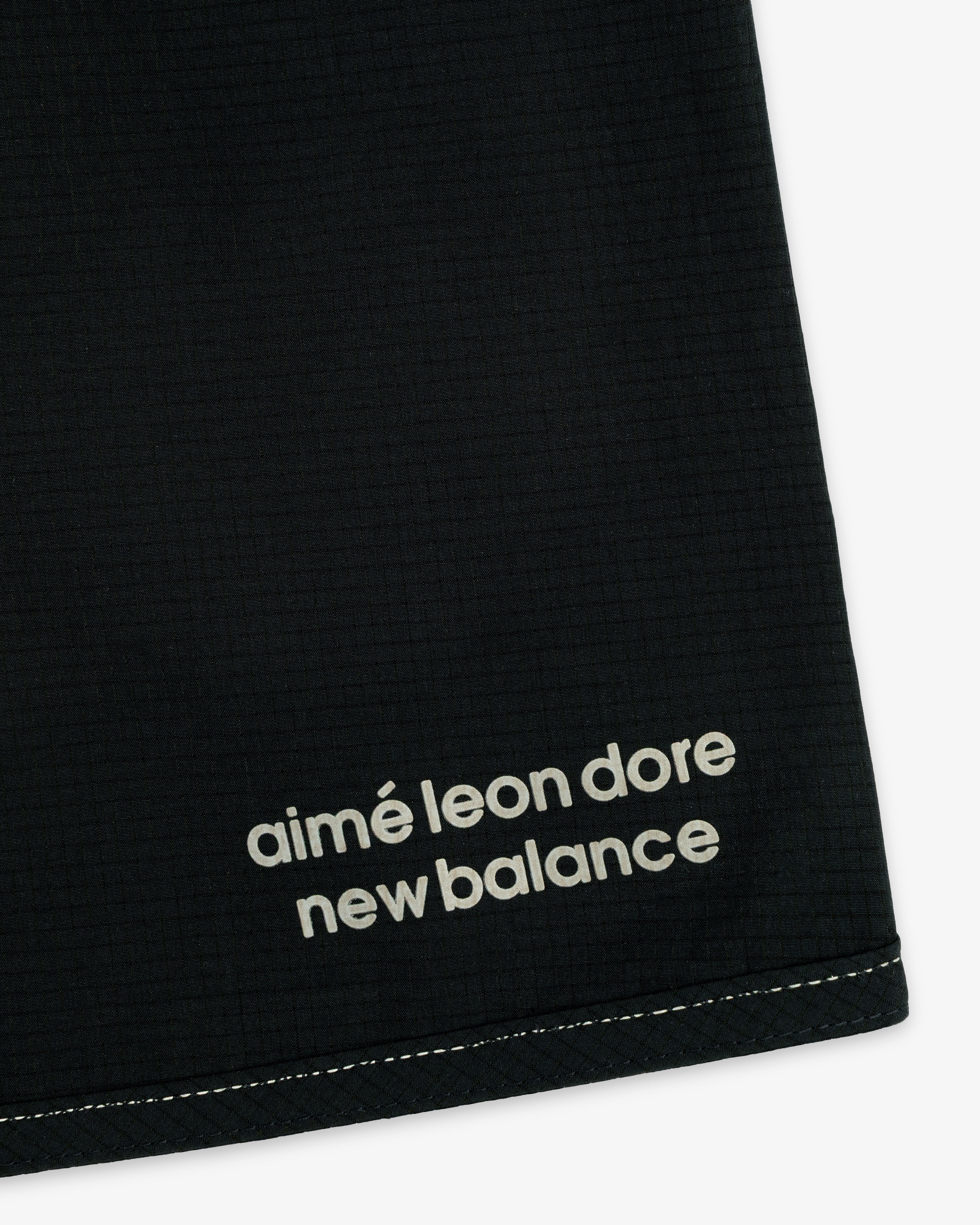 Black ALD / New Balance Performance Lightweight Running Short with white logo near a stitched edge.