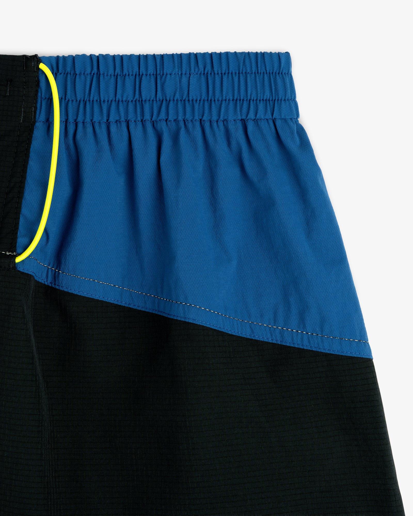 Close-up of ALD / New Balance Performance Lightweight Running Short with elastic waistband and yellow drawstring.