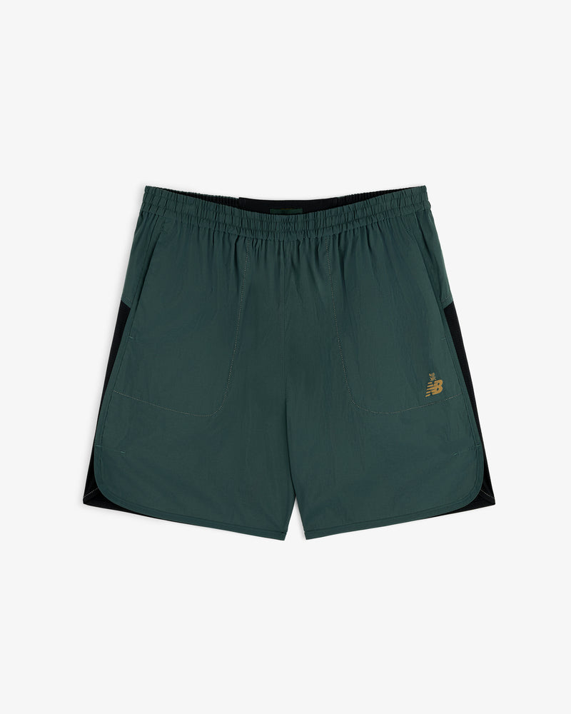 ALD / New Balance Performance Lightweight Running Short in dark green with black panels and gold logo on left leg.