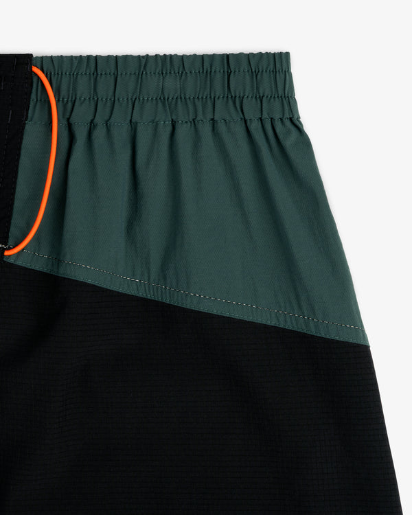 Close-up of ALD / New Balance Performance Lightweight Running Short with dark green, black panels, and orange drawstring.