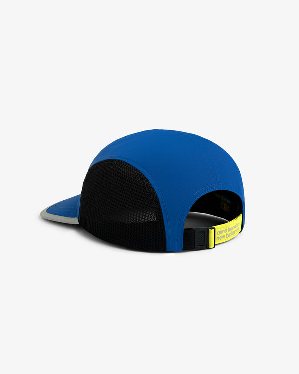 ALD / New Balance Mesh Sport Hat in blue and black, shown from the back with a yellow adjustable strap and flat brim.