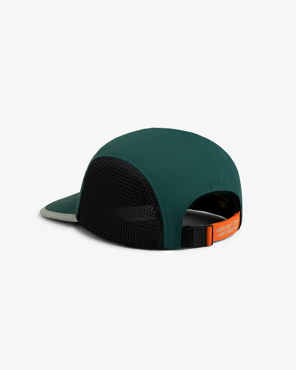 ALD / New Balance Mesh Sport Hat in green and black with adjustable strap, orange label; back view on white background.