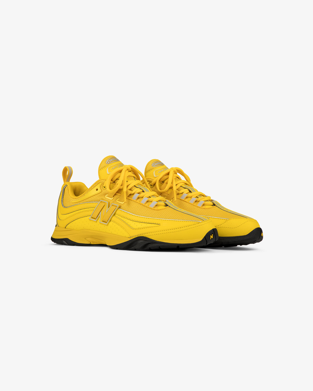 ALD / New Balance RC56 sneakers in bright yellow with black soles, shown angled on a white background.
