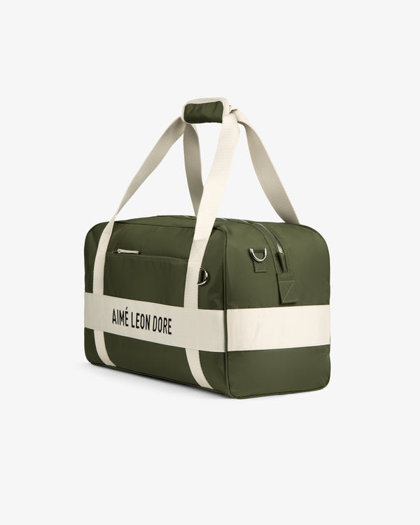 A green Nylon Duffle Bag with white straps and AIMÉ LEON DORE text, shown on a white background.