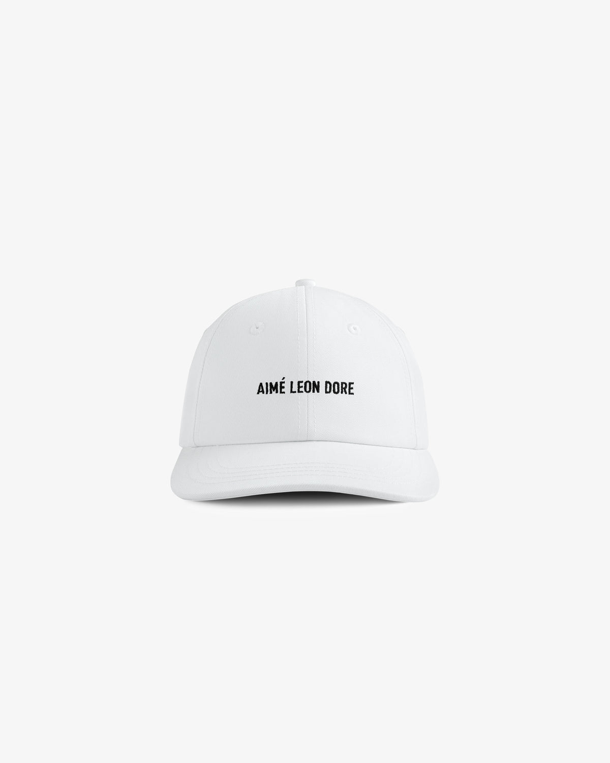 The Core Logo Hat is a white baseball cap featuring AIMÉ LEON DORE in black on the front, set against a plain background.
