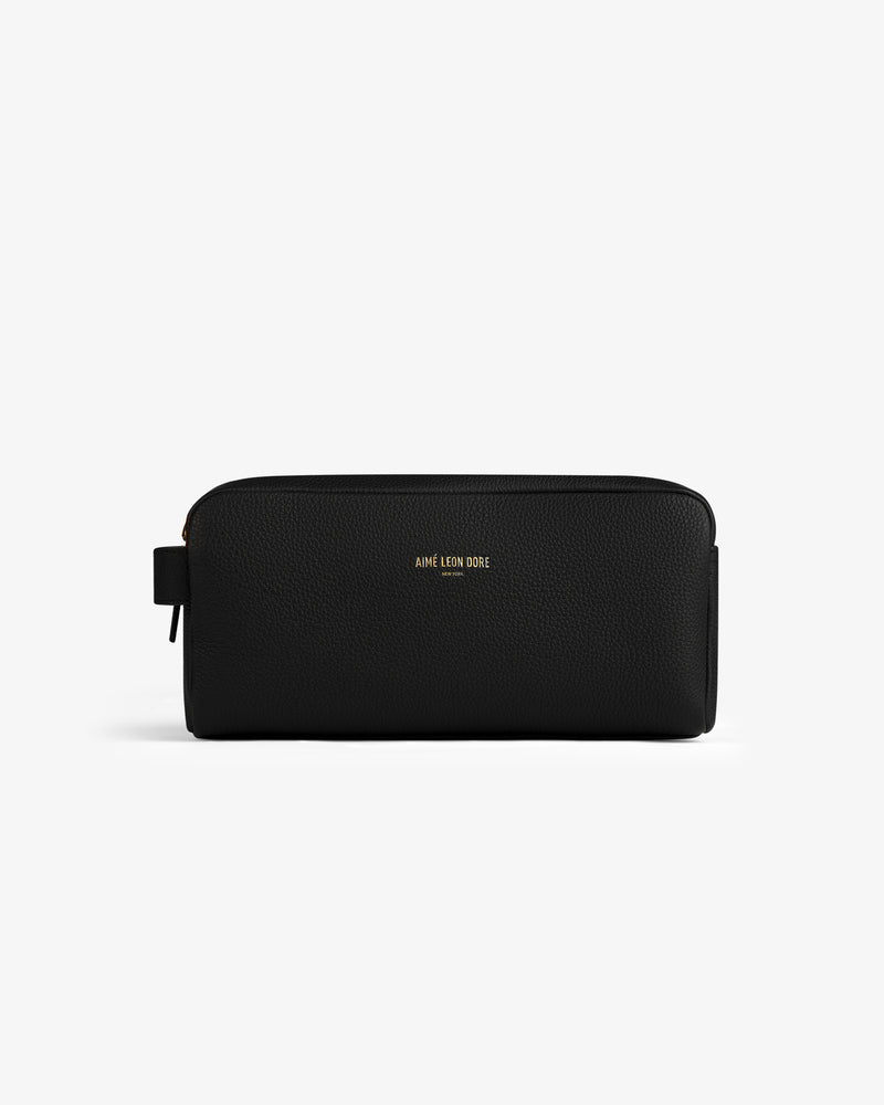 The Leather Traveler Kit is a black leather toiletry bag with a zipper and gold AIMÉ LEON DORE lettering on the front.