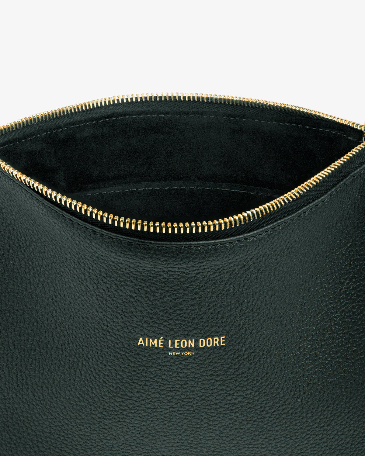 A close-up of the Small Leather Pouch in black with a gold zipper and AIMÉ LEON DORE NEW YORK embossed in gold.