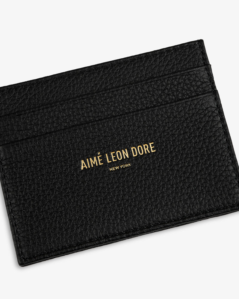 Leather Card Holder in black textured leather with AIMÉ LEON DORE NEW YORK gold lettering on the front.
