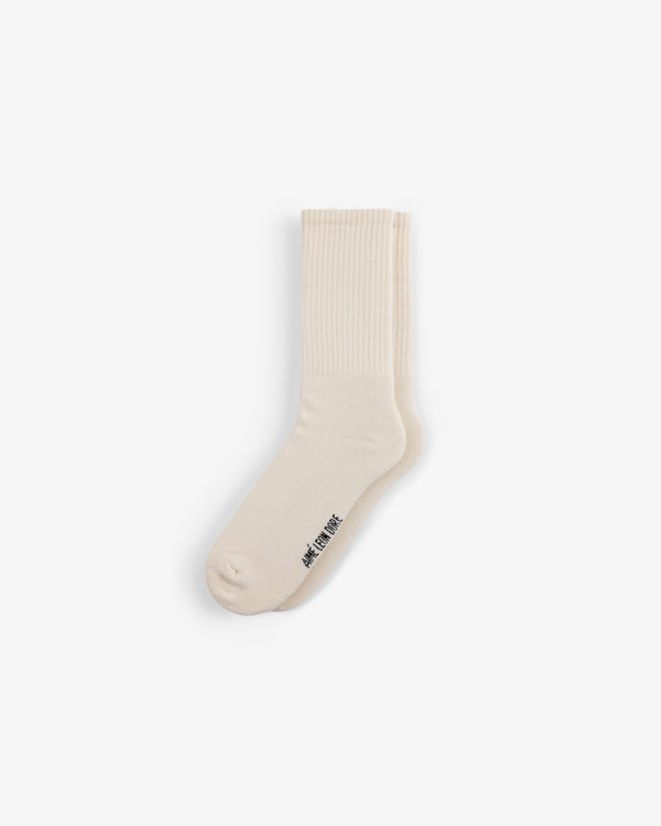 A single cream crew sock from the Crew Sock 3-Pack with ribbed details and small black text near the toe on white.