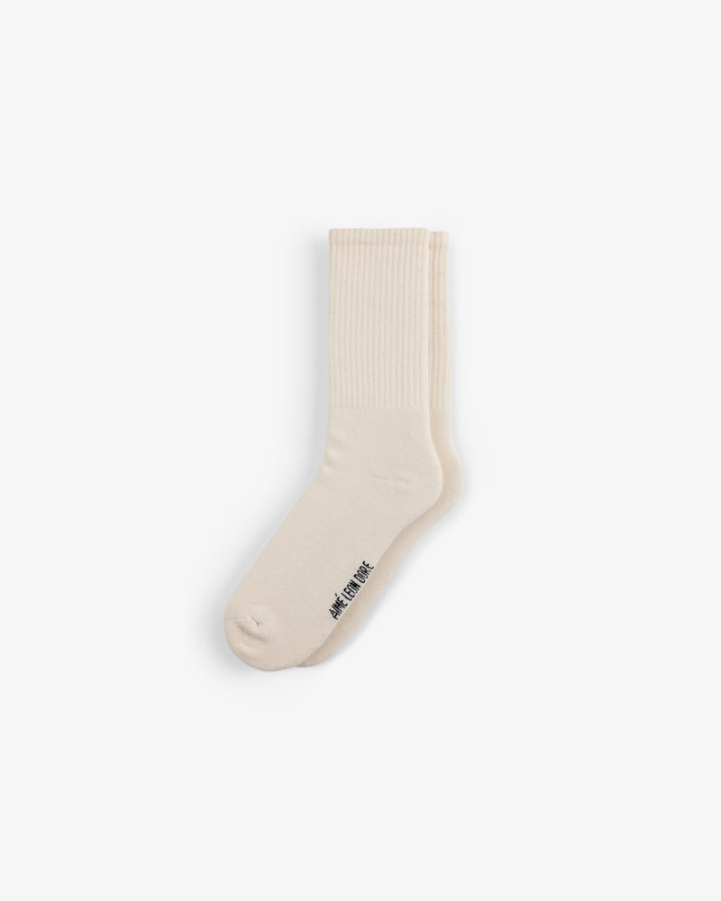 A single cream crew sock from the Crew Sock 3-Pack with ribbed details and small black text near the toe on white.