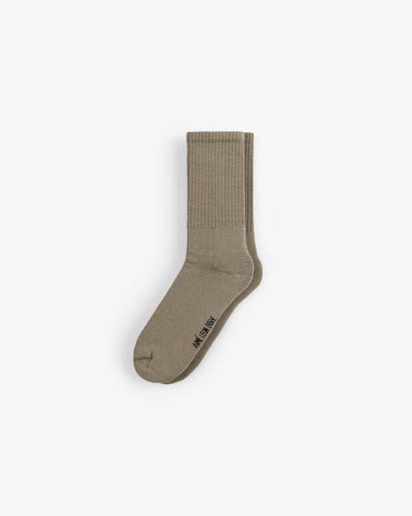 A single beige Crew Sock 3-Pack sock with ribbed ankle and WE11DONE text near the toe, on a plain white background.