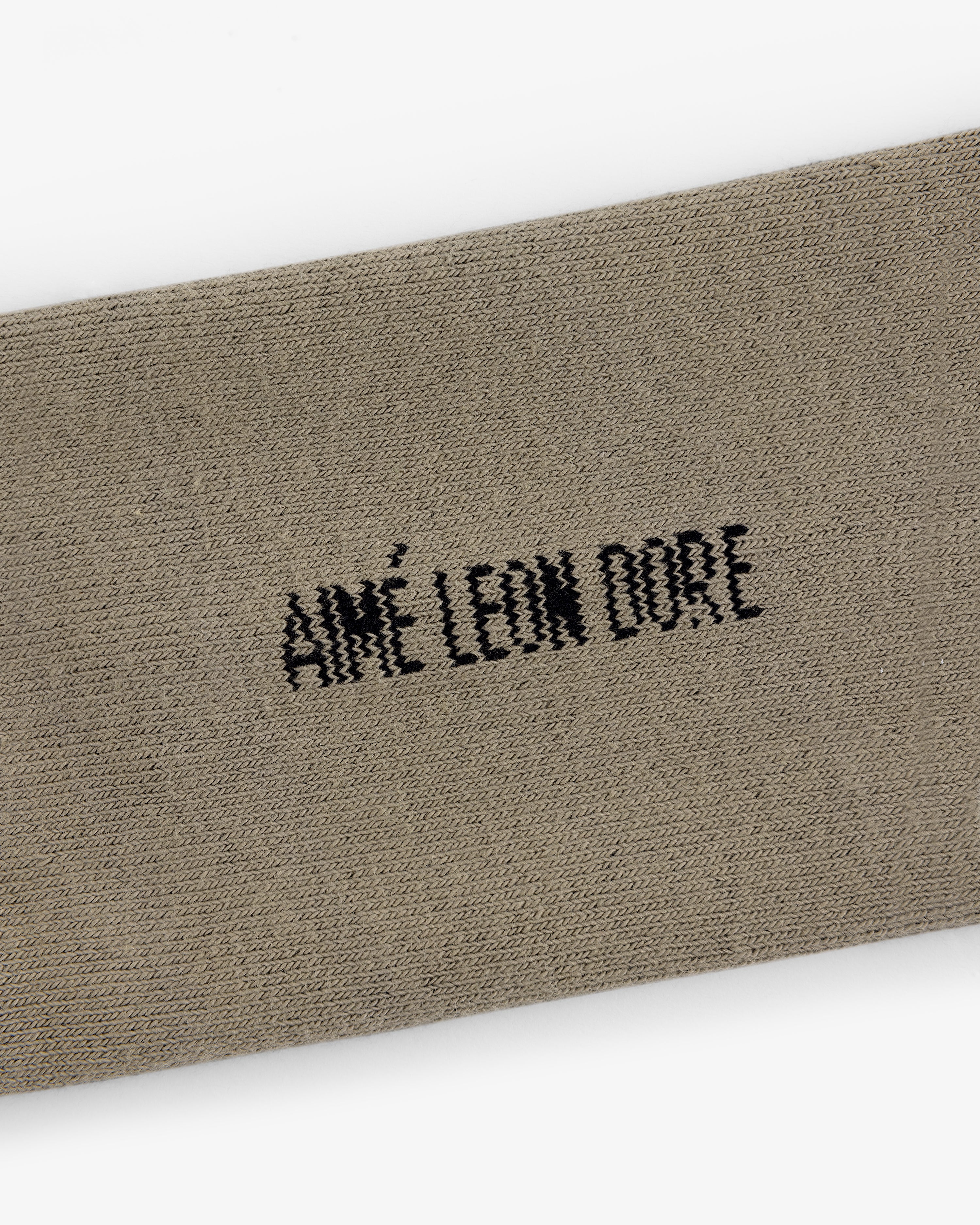 Beige Crew Sock 3-Pack with black AIMÉ LEON DORE embroidery centered on the fabric.