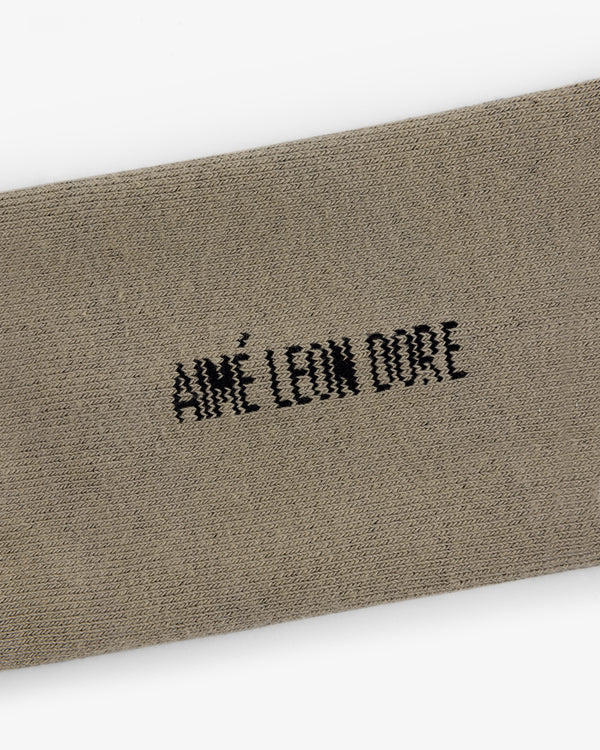Beige Crew Sock 3-Pack with black AIMÉ LEON DORE embroidery centered on the fabric.