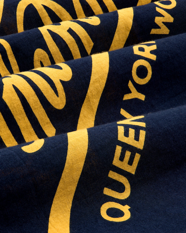 Yellow text and designs on dark blue Unisphere Bandana, showing part of the phrase "QUEEKYOR WO.