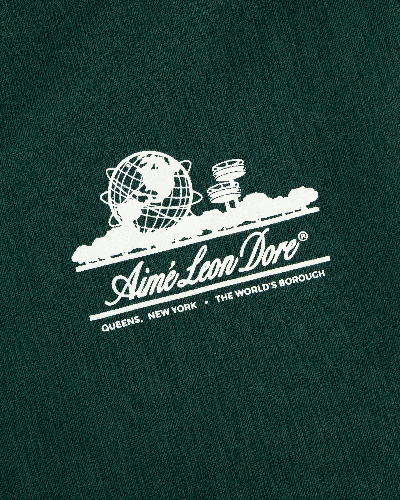 Dark green Unisphere Sweatpants featuring a white Aimé Leon Dore globe logo above text.