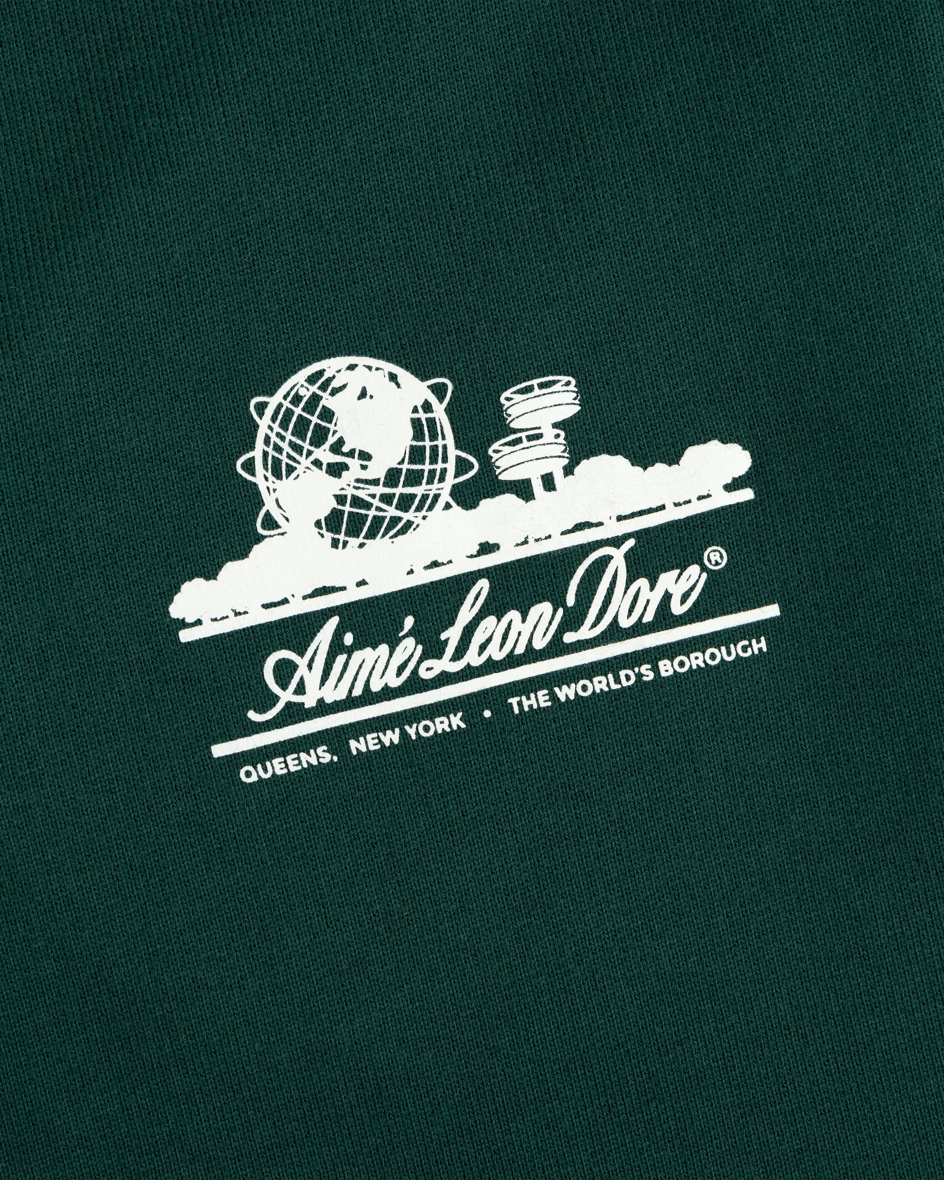 Dark green Unisphere Sweatpants featuring a white Aimé Leon Dore globe logo above text.