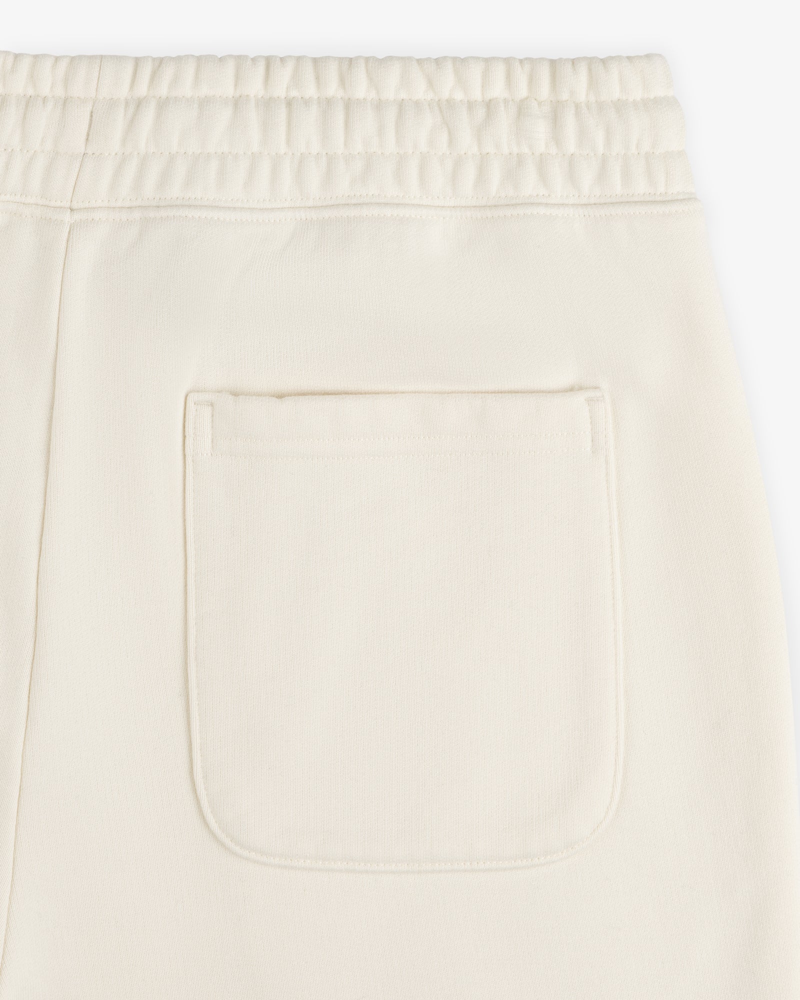 Close-up of Unisphere Sweatpants in cream with an elastic waistband and single back patch pocket.