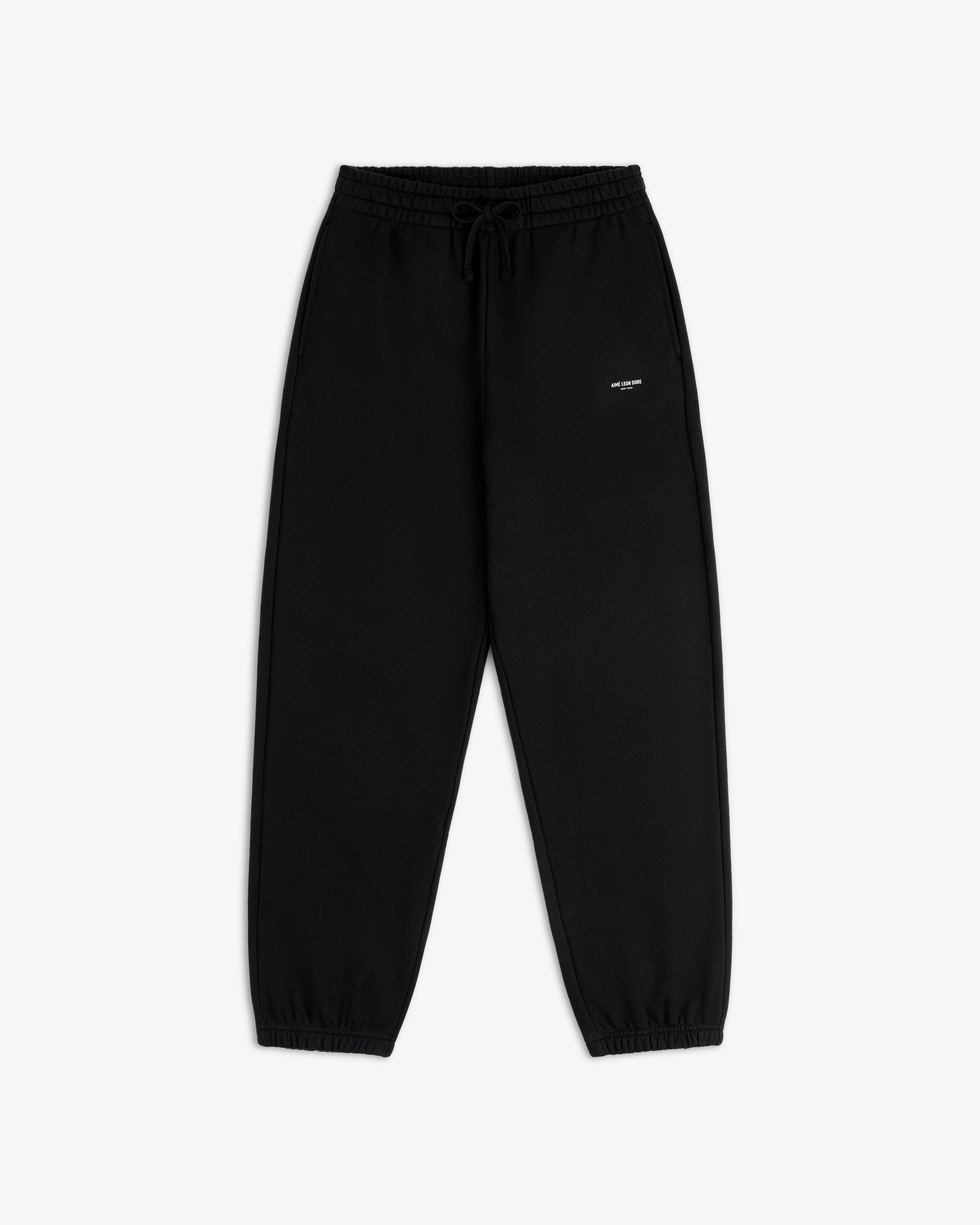 Micro Logo Sweatpants in black with elastic cuffs and a small white logo on the left hip, shown flat on white.