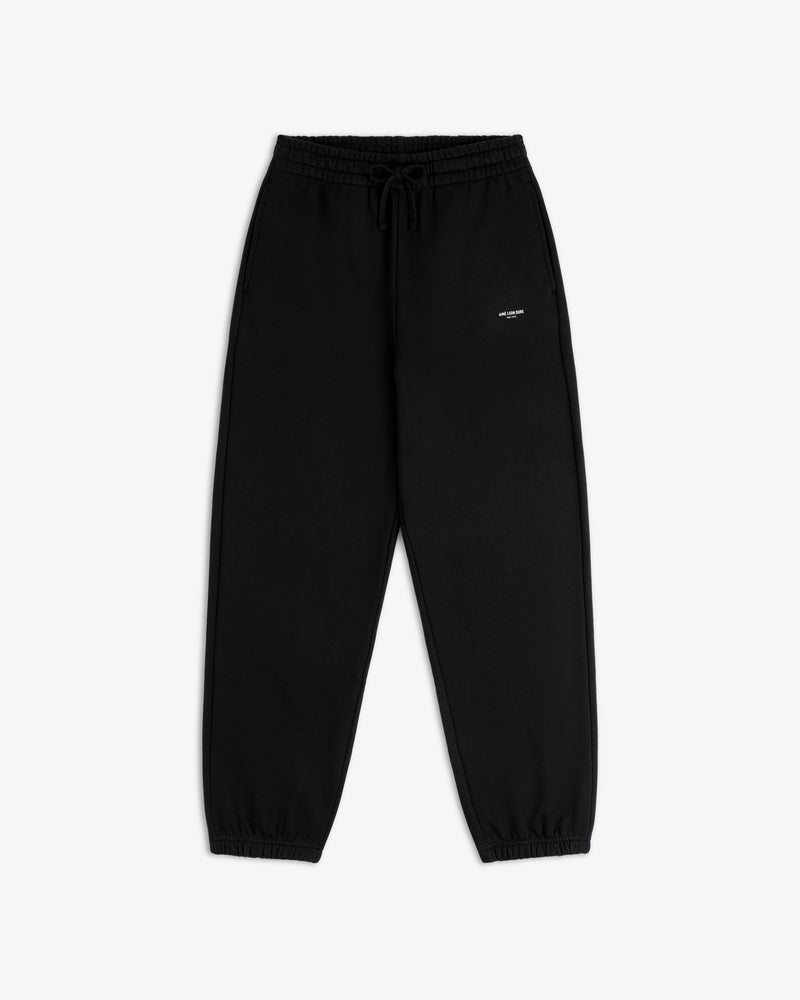 Micro Logo Sweatpants in black with elastic cuffs and a small white logo on the left hip, shown flat on white.