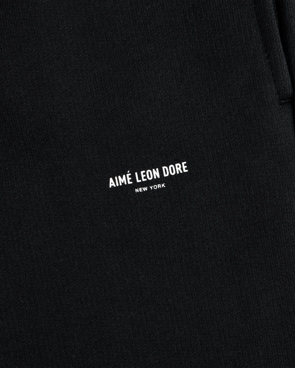 Close-up of black Micro Logo Sweatpants with AIMÉ LEON DORE NEW YORK in small white letters.