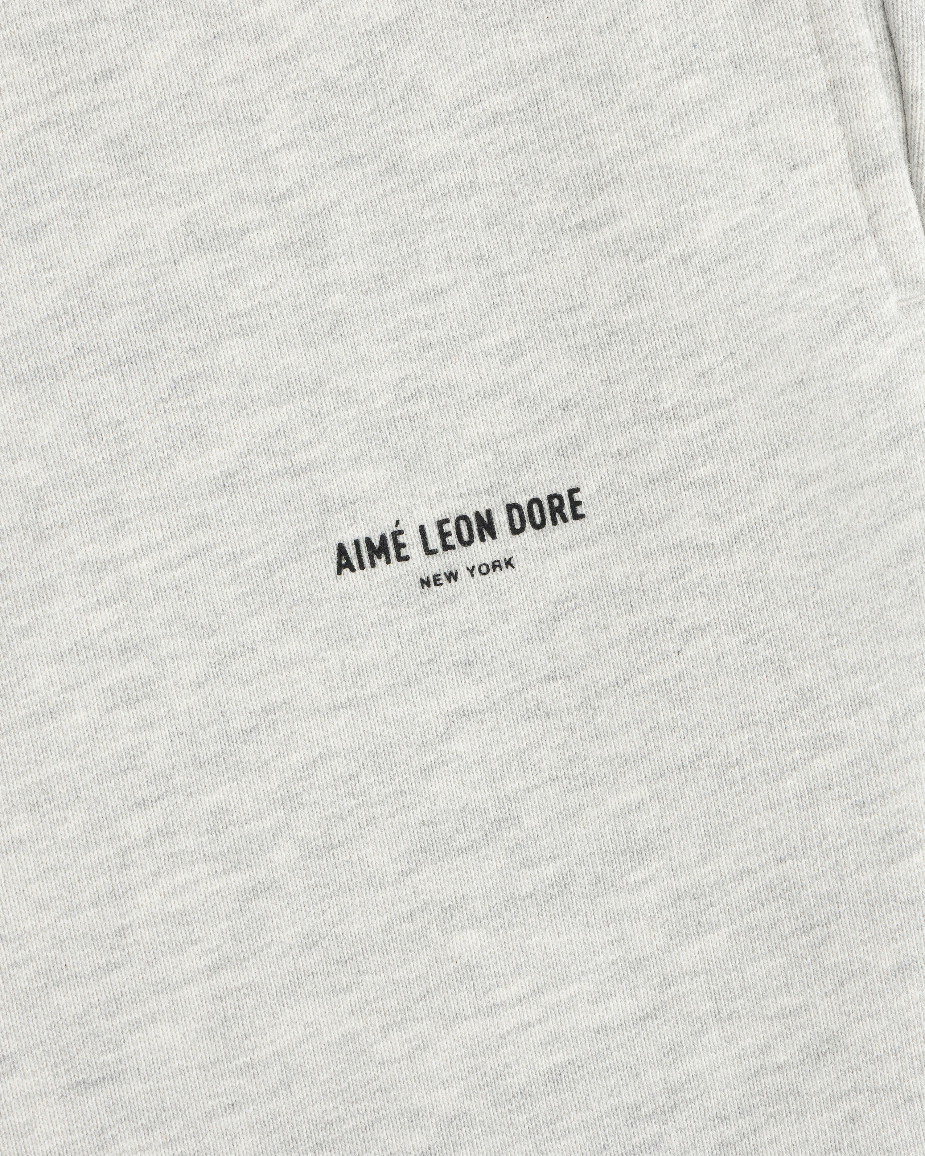 Close-up of light gray Micro Logo Sweatpants with minimalist black AIMÉ LEON DORE NEW YORK print.