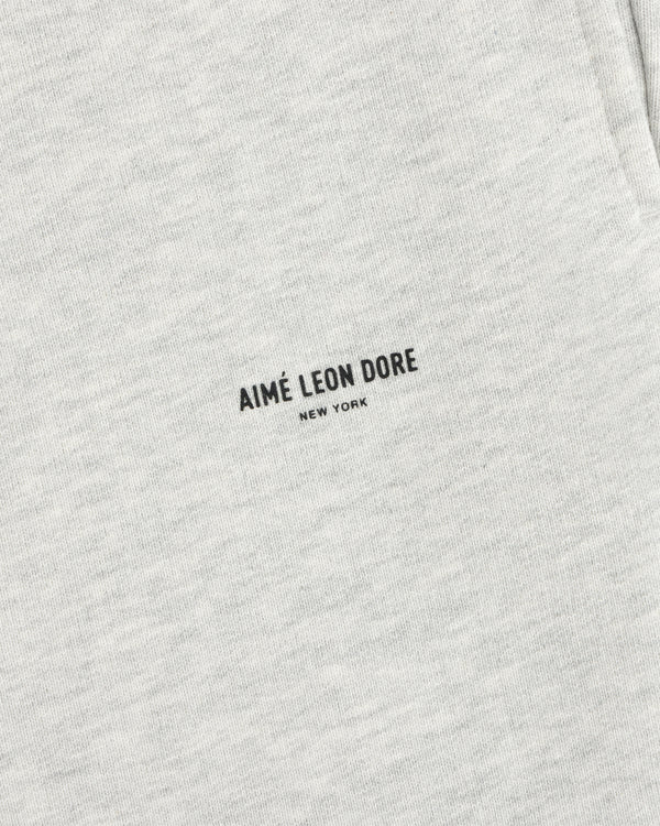 Close-up of light gray Micro Logo Sweatpants with minimalist black AIMÉ LEON DORE NEW YORK print.