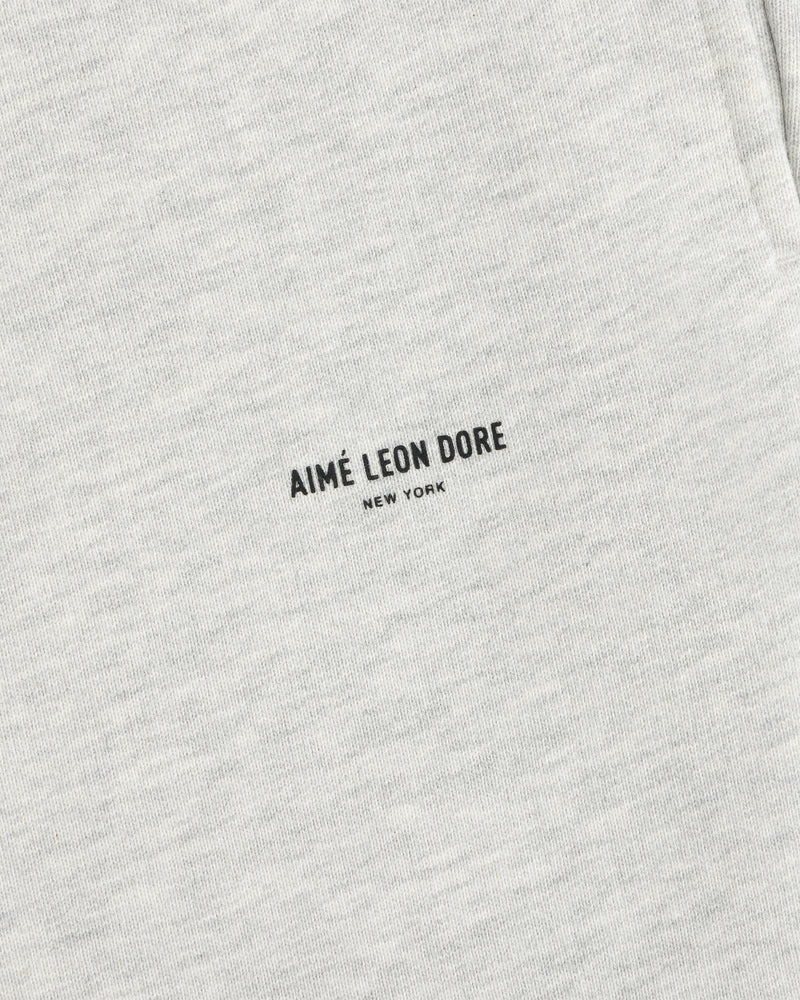 Close-up of light gray Micro Logo Sweatpants with minimalist black AIMÉ LEON DORE NEW YORK print.