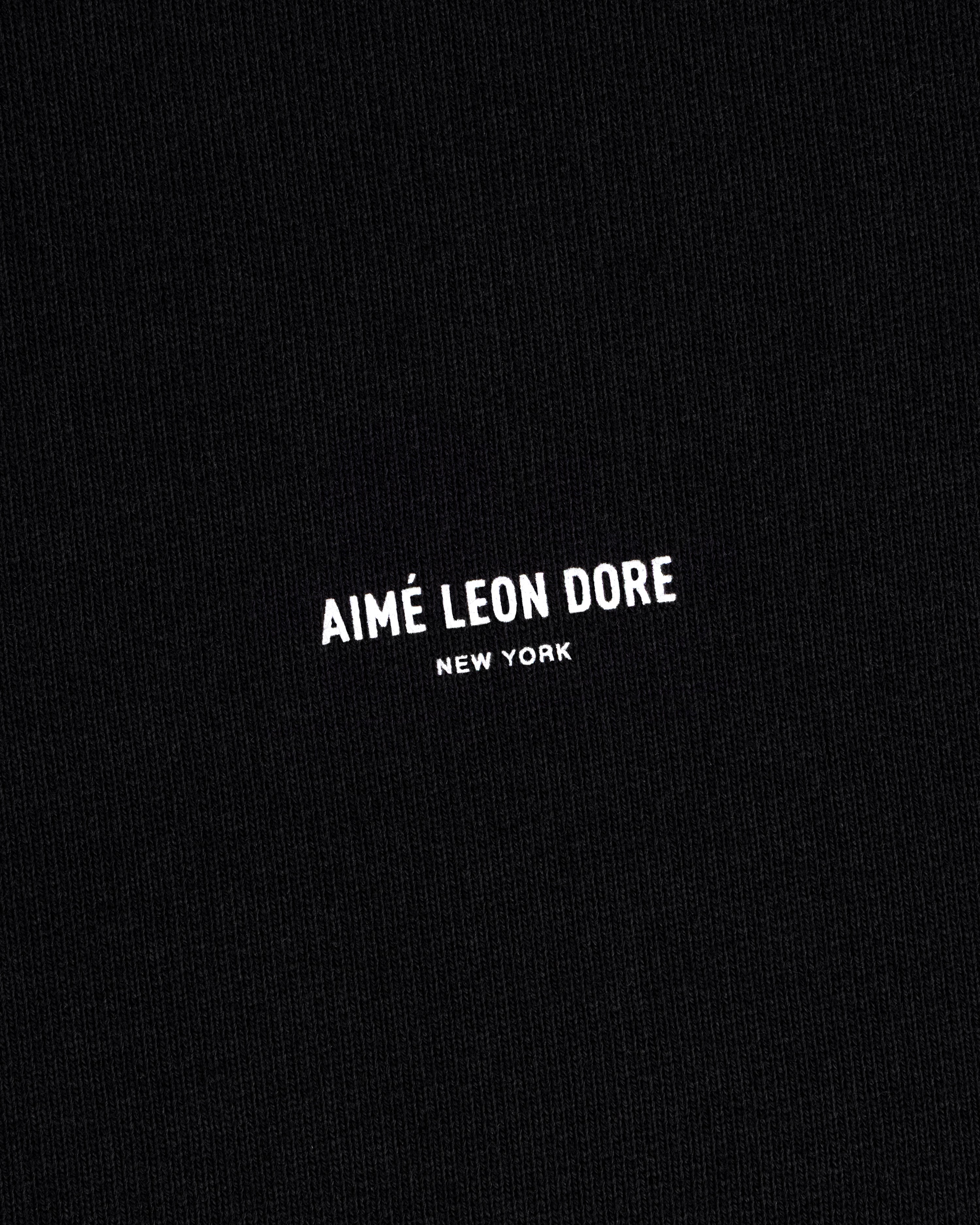 Black Micro Logo Crewneck Sweatshirt with small white Aimé Leon Dore New York print centered on fabric.