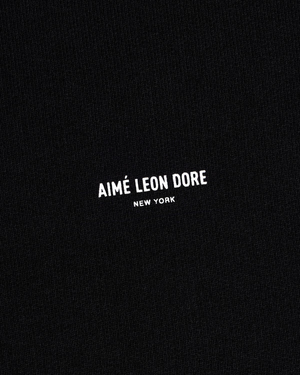 Black Micro Logo Crewneck Sweatshirt with small white Aimé Leon Dore New York print centered on fabric.