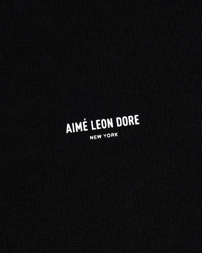 Black Micro Logo Crewneck Sweatshirt with small white Aimé Leon Dore New York print centered on fabric.