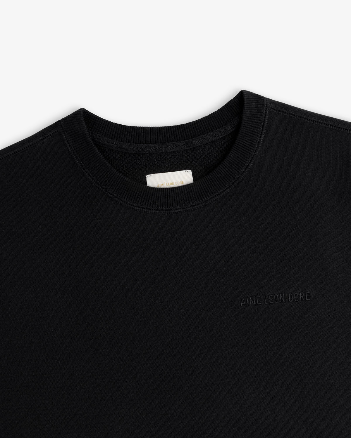 Tonal Logo Crewneck Sweatshirt in black with subtle chest embroidery, shown against a white background.
