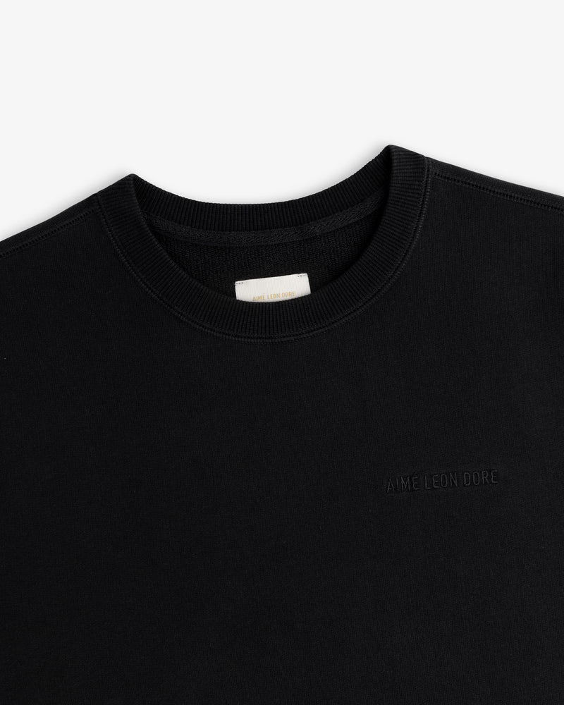 Tonal Logo Crewneck Sweatshirt in black with subtle chest embroidery, shown against a white background.