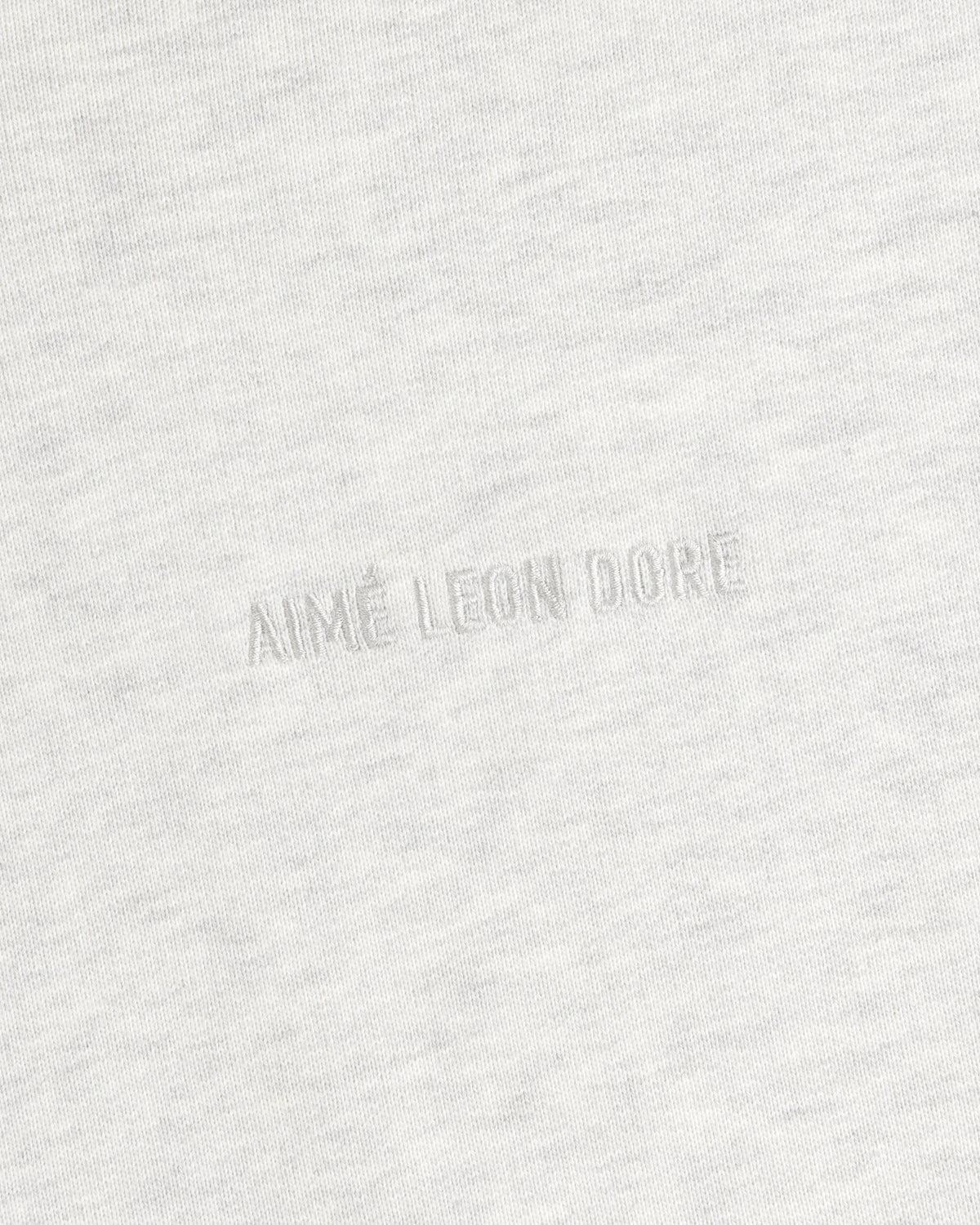 Close-up of light gray Tonal Logo Crewneck Sweatshirt with AIMÉ LEON DORE subtly embossed at the center.
