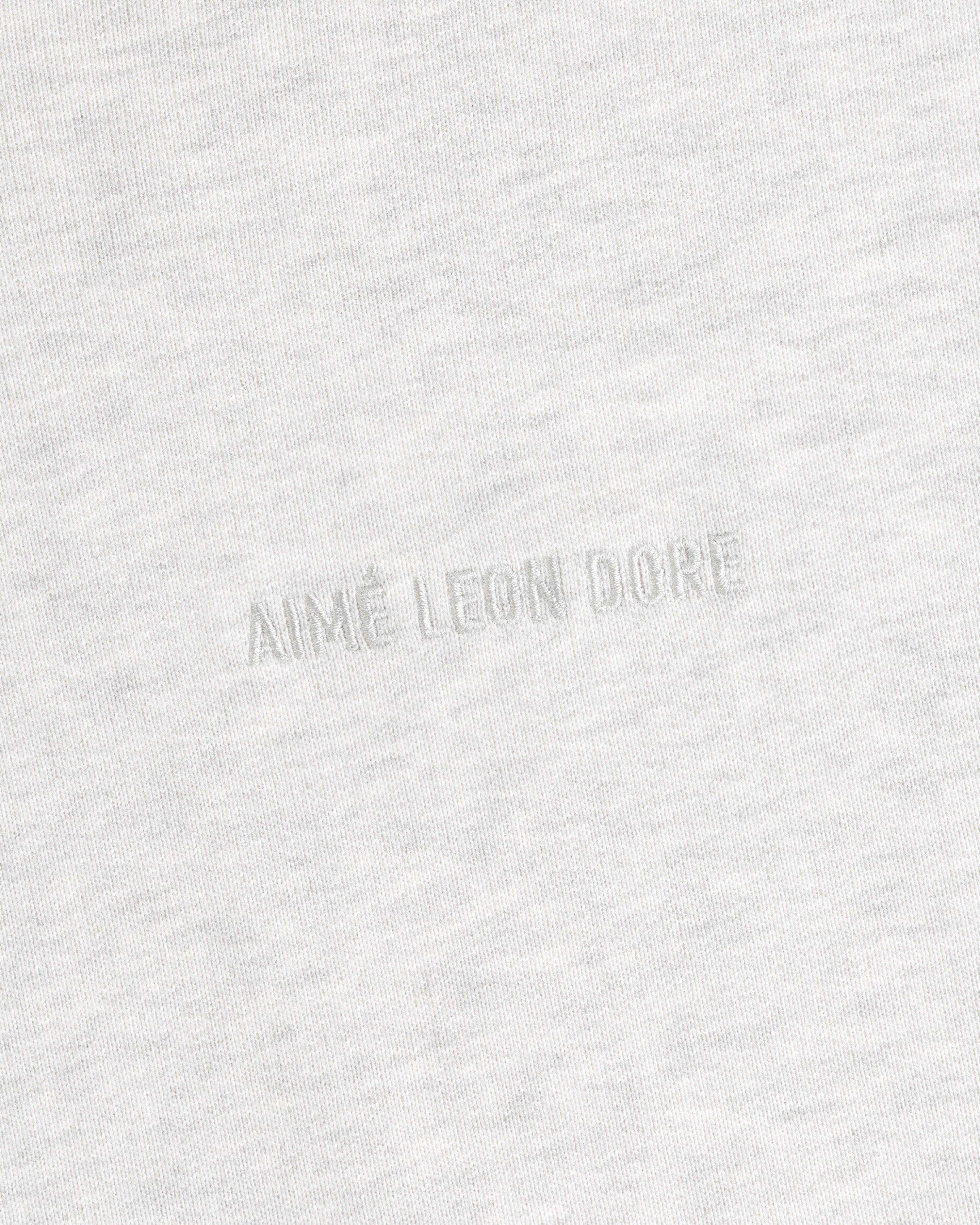 Close-up of light gray Tonal Logo Crewneck Sweatshirt with AIMÉ LEON DORE subtly embossed at the center.