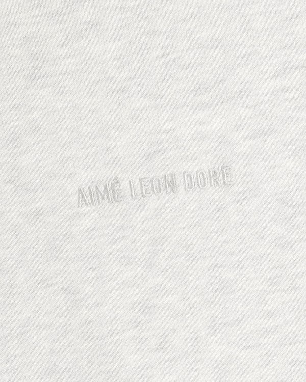 Close-up of light gray Tonal Logo Crewneck Sweatshirt with AIMÉ LEON DORE subtly embossed at the center.