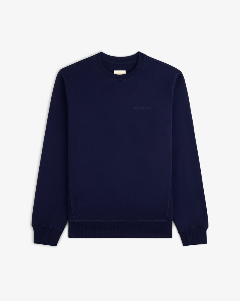 Tonal Logo Crewneck Sweatshirt in navy blue with long sleeves, shown flat on a white background.