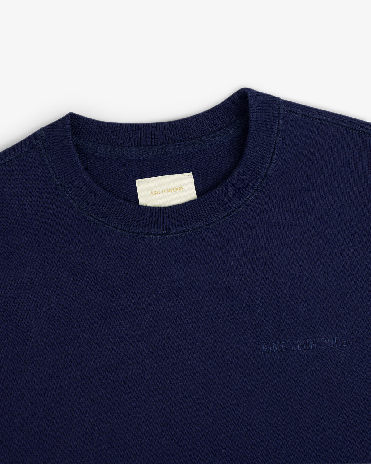 Navy Tonal Logo Crewneck Sweatshirt with AIMÉ LEON DORE chest embroidery and a cream neck tag.
