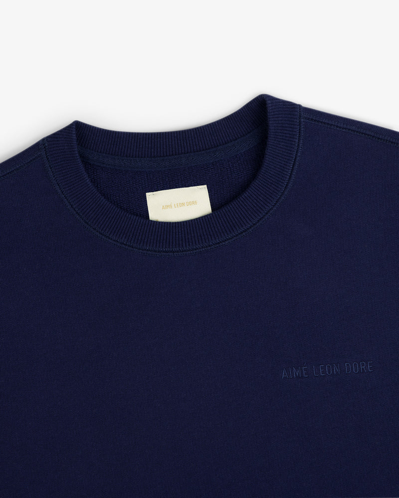 Navy Tonal Logo Crewneck Sweatshirt with AIMÉ LEON DORE chest embroidery and a cream neck tag.