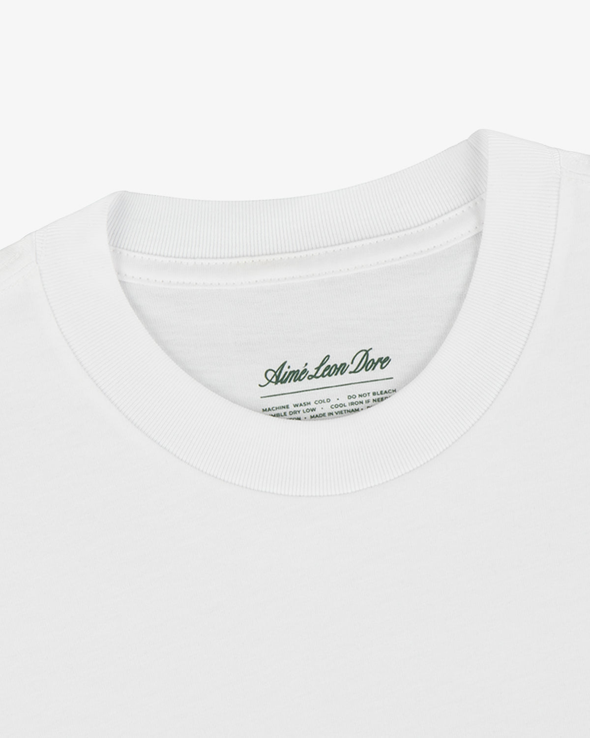 Close-up of a white T-Shirt 3-Pack with a ribbed crew neck and an Aimé Leon Dore label inside the collar.