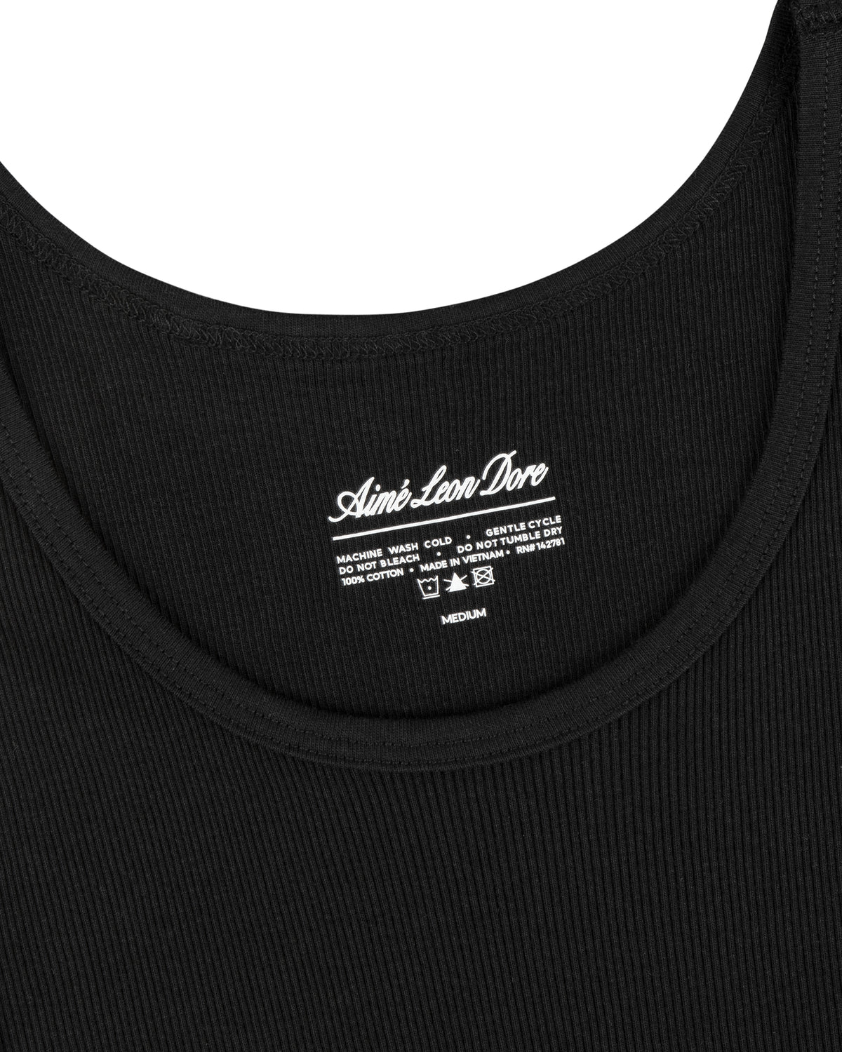 Close-up of a black ribbed Tank Top 3-Pack with care instructions printed inside the neckline.