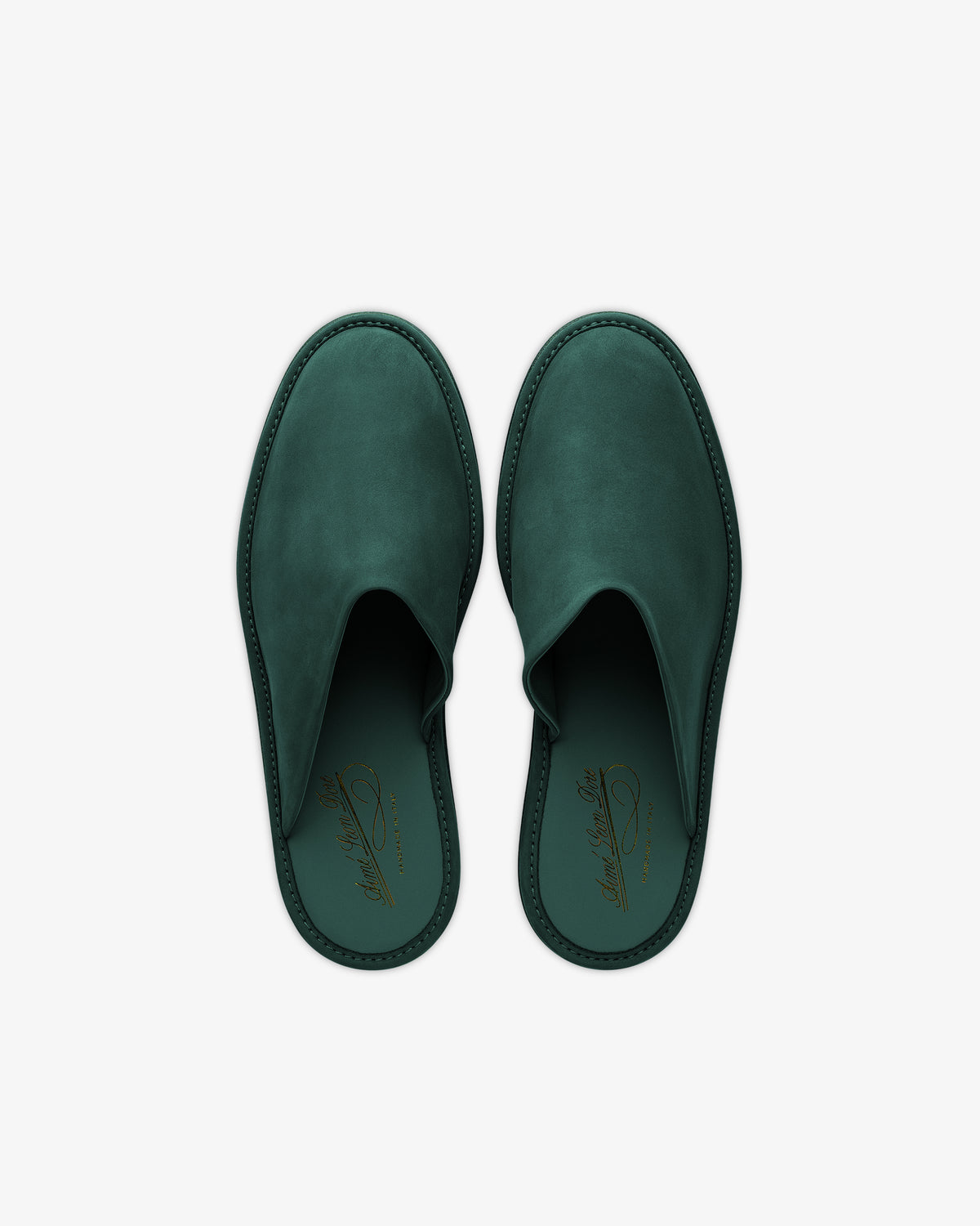A pair of Nubuck Travel Slipper in dark green leather, gold logo insoles, seen from above on a white background.