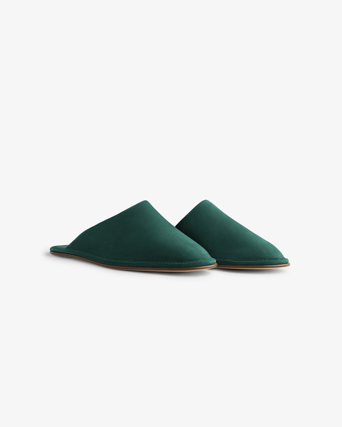 A pair of Nubuck Travel Slippers in dark green with flat soles displayed on a white background.