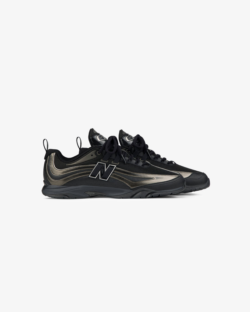 The ALD / New Balance RC56 sneakers in black and metallic with black laces and a large N logo, on white background.