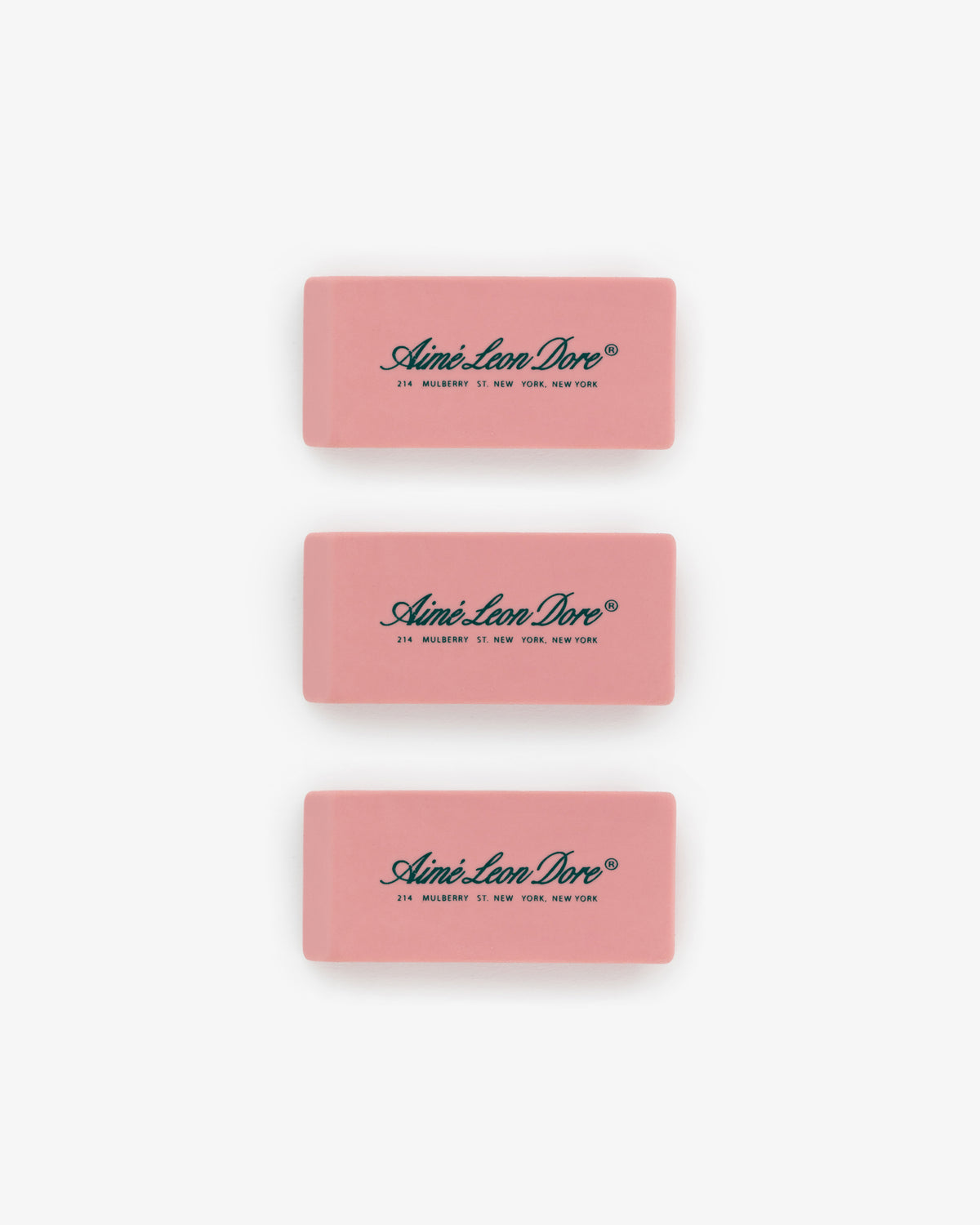 Eraser 3 Pack: three pink rectangular erasers with black Aimé Leon Dore branding on a white background.