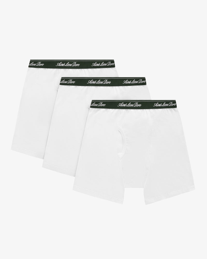 Boxer Brief 3-Pack: three white pairs with black waistbands featuring white cursive text, arranged in a row.