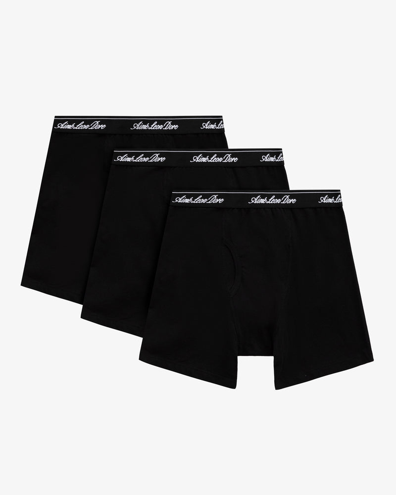 Boxer Brief 3-Pack: Three black pairs with black waistbands and white script, shown on a white background.